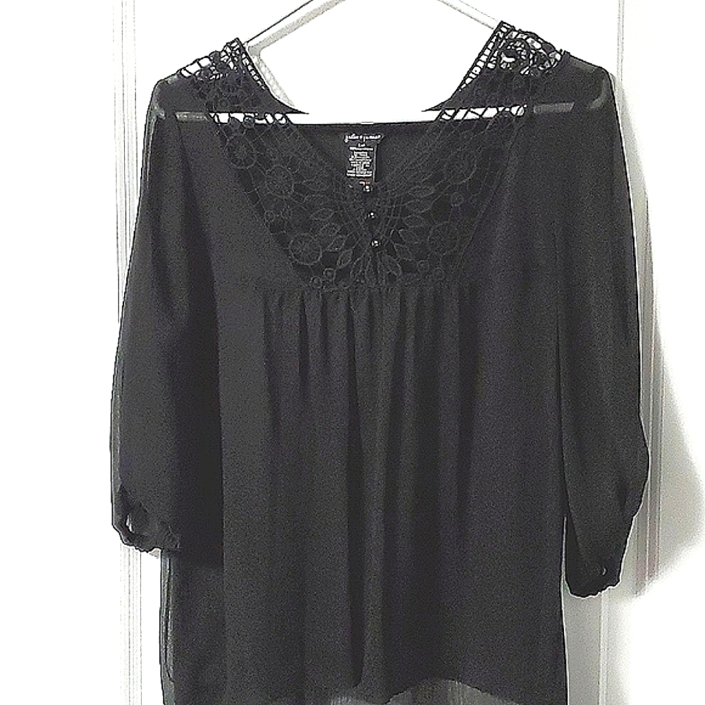 Black top with crochet lace in the front.